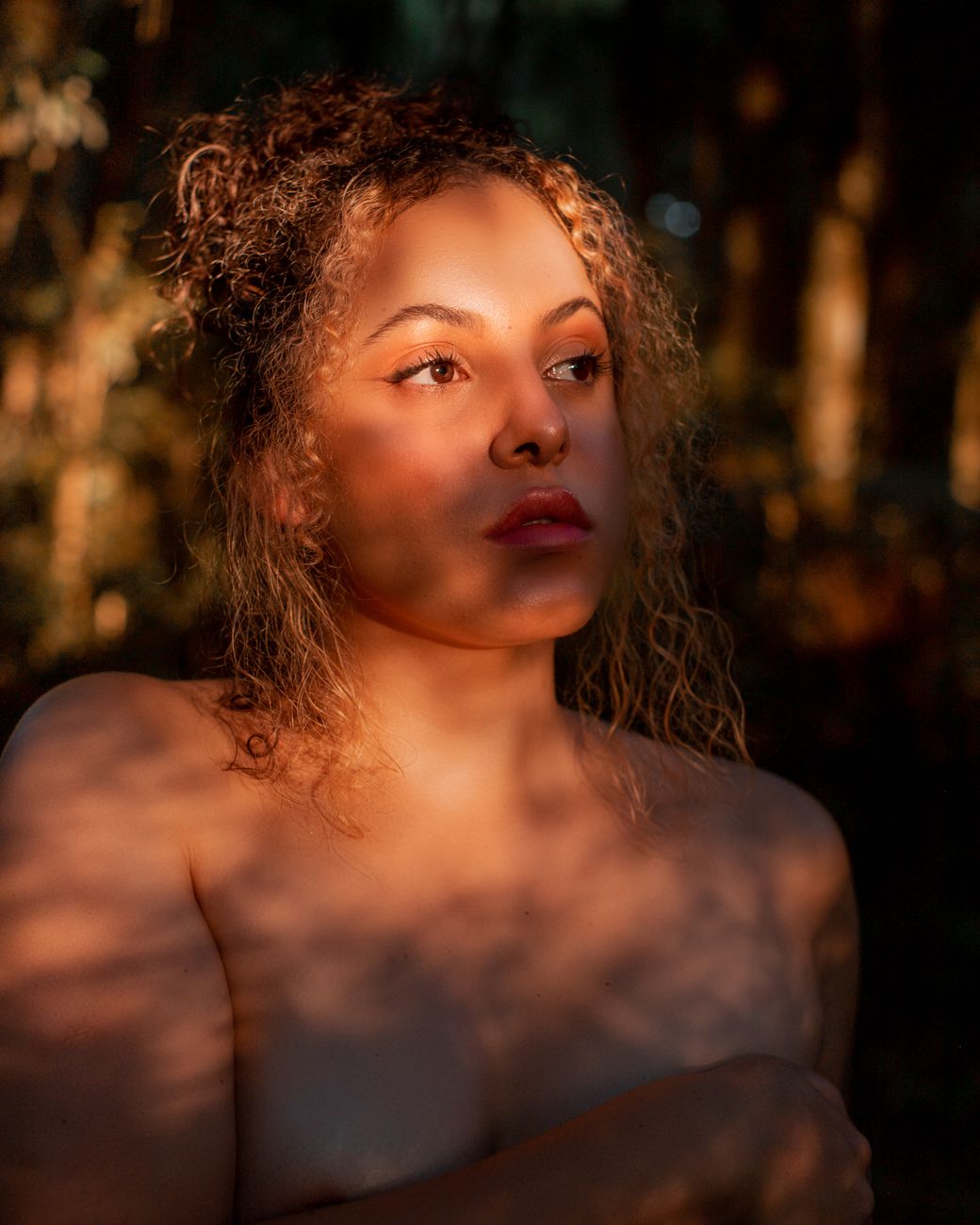 Woman with radiant, natural skin in warm backlight