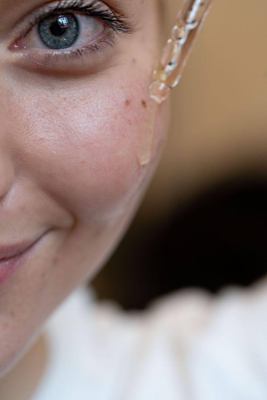 Close-up of dewy, radiant skin with fine water droplets