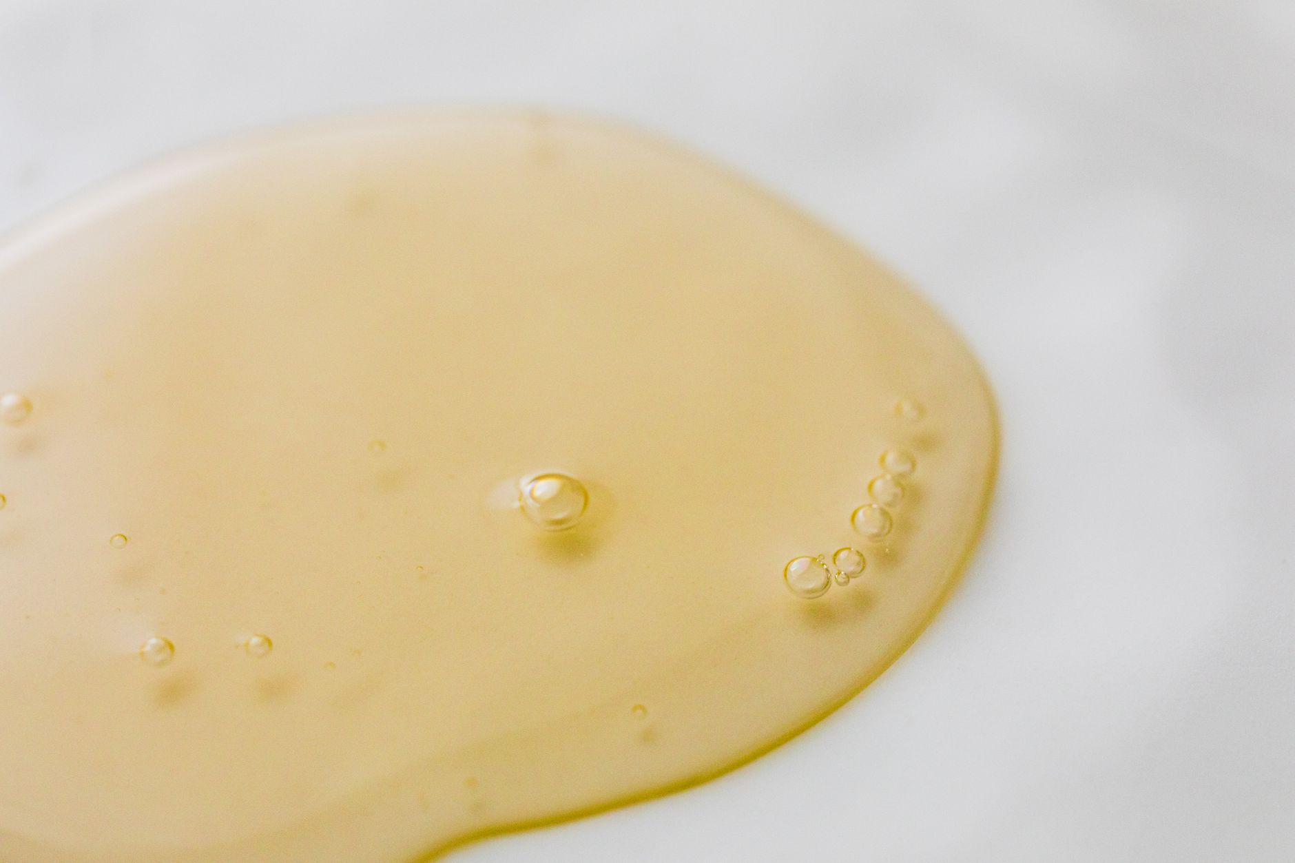 Golden serum texture, macro